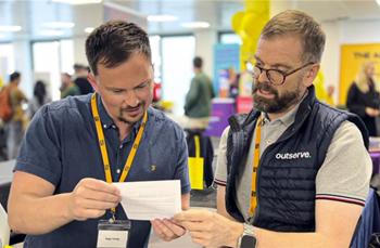 photo from an event with two staff members from Outserve