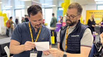 photo from an event with two staff members from Outserve