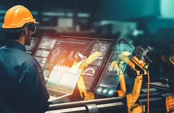 worker using  a laptop in an industrial machinery building