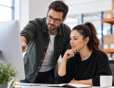 men and woman looking at a desktop