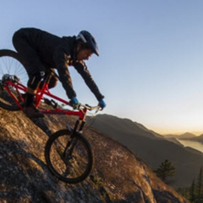 person riding a banshee bike downhill