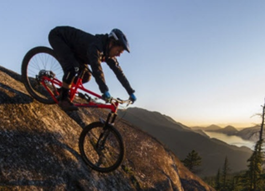 person riding a banshee bike downhill