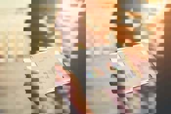 Person reading business report on a tablet within a facility