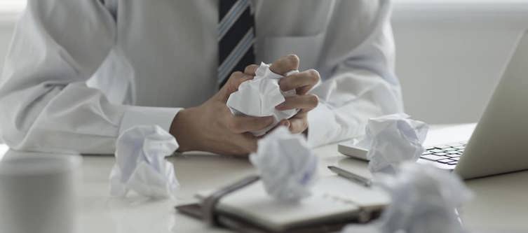 hands crumbling paper