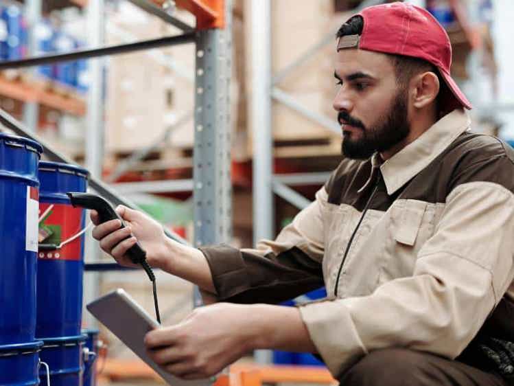 Man scanning barcode on a barrel