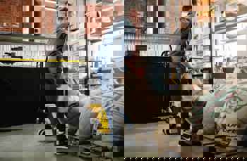 worker lifting heavy bag in a warehouse