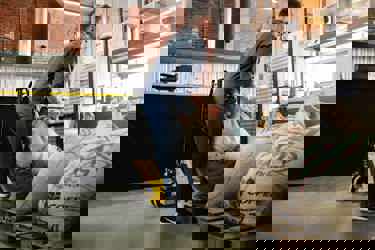 worker lifting heavy bag in a warehouse