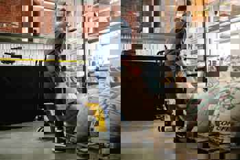 worker lifting heavy bag in a warehouse