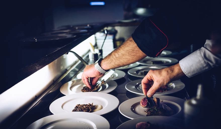 Man plating food in a restaurant