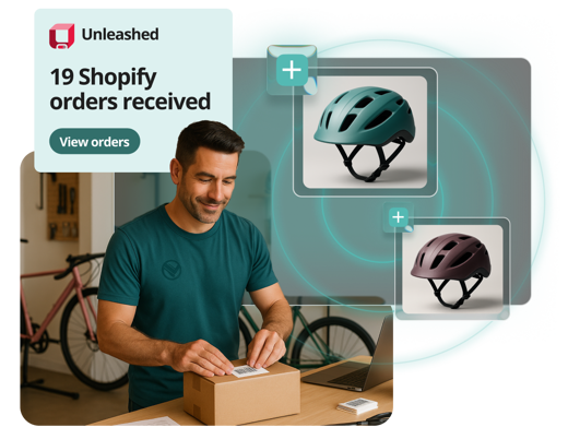 photo of a man boxing a package with two bike helmets and a message indicating unleashed's integration with shopify