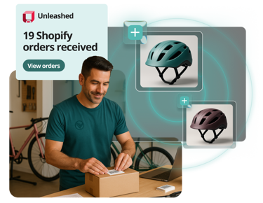 photo of a man boxing a package with two bike helmets and a message indicating unleashed's integration with shopify